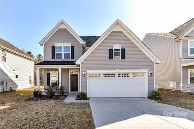 traditional home featuring covered porch, concrete driveway, and an attached garage