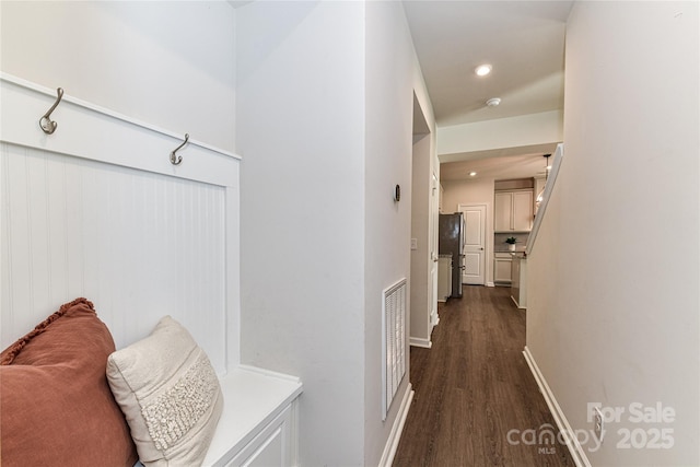 hall featuring dark wood-style floors, visible vents, recessed lighting, and baseboards