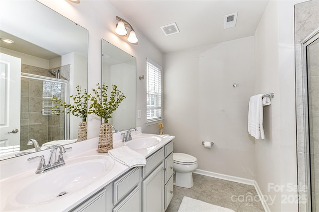 bathroom with tiled shower, visible vents, and a sink