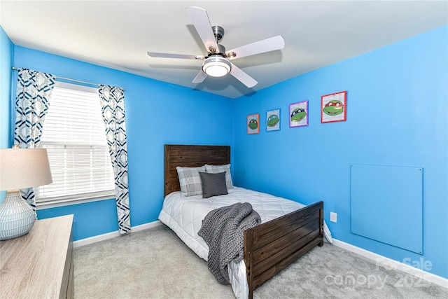 carpeted bedroom featuring ceiling fan and baseboards