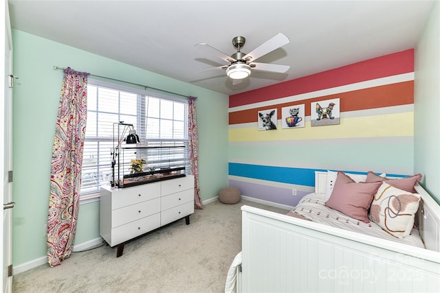 bedroom featuring baseboards, light colored carpet, and ceiling fan