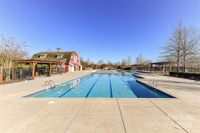 community pool featuring a pergola, a patio, and fence