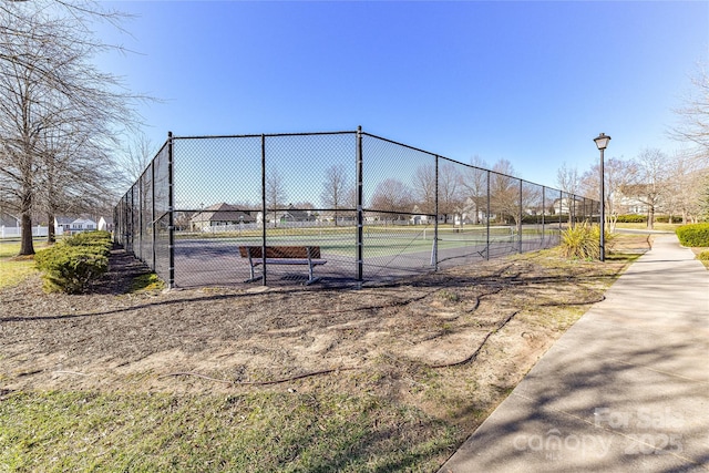 view of sport court with fence