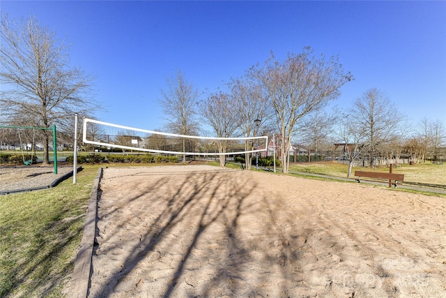 view of community with volleyball court and driveway