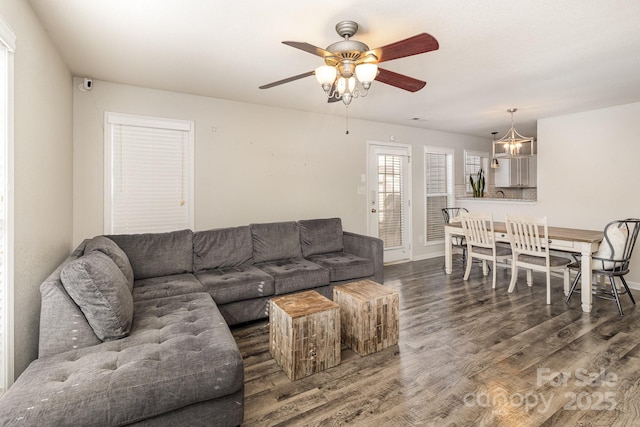 living area with wood finished floors and a ceiling fan