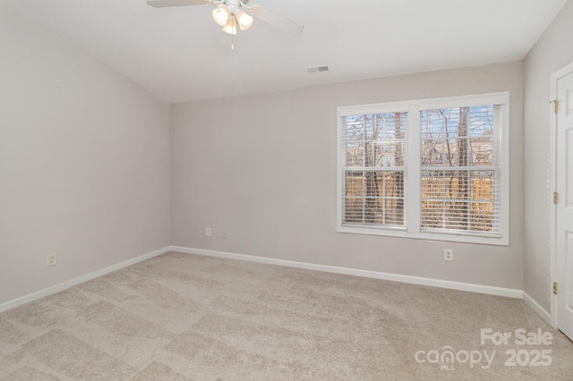 empty room with light carpet, visible vents, baseboards, and a ceiling fan