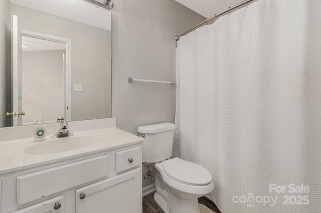 bathroom featuring vanity, toilet, and a shower with curtain