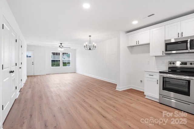 kitchen featuring white cabinetry, light wood-style floors, tasteful backsplash, and stainless steel appliances