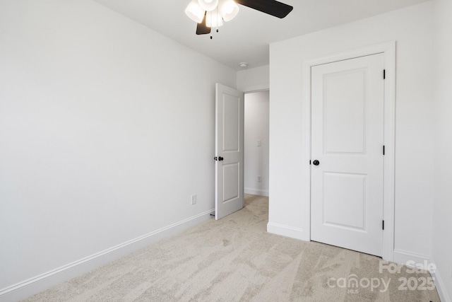 unfurnished bedroom featuring a ceiling fan, baseboards, and carpet floors