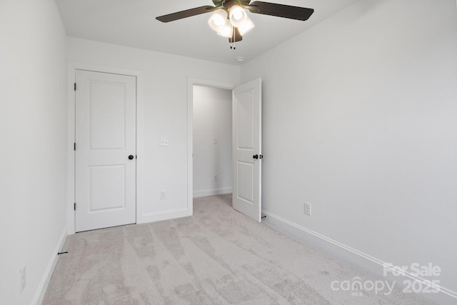 unfurnished bedroom with baseboards, carpet floors, and ceiling fan