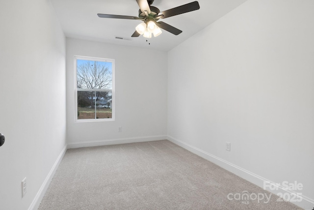 empty room featuring carpet flooring, visible vents, baseboards, and ceiling fan