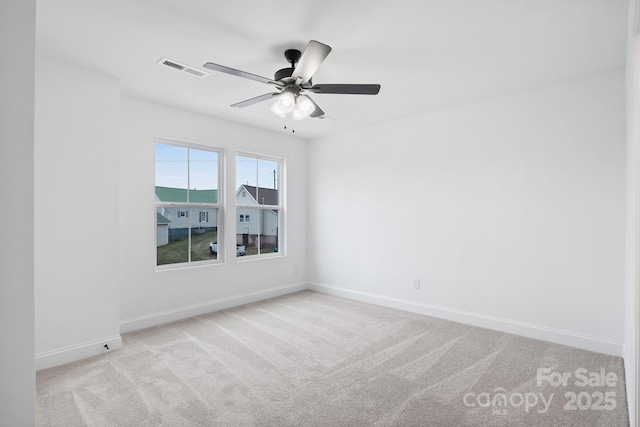 spare room with visible vents, baseboards, carpet, and a ceiling fan