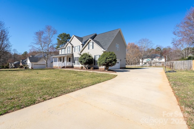 view of front of property featuring driveway, an attached garage, covered porch, fence, and a front lawn