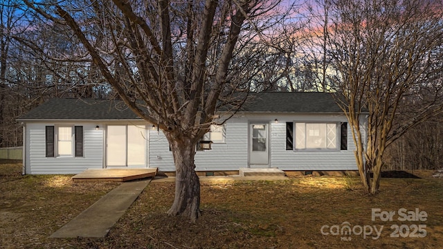 single story home with roof with shingles and crawl space