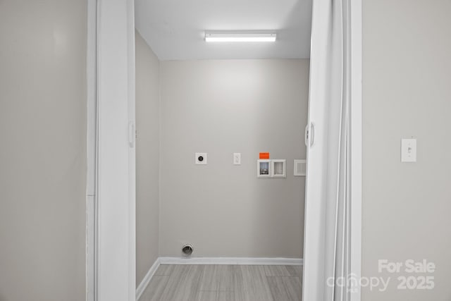 laundry area with hookup for a washing machine, laundry area, hookup for an electric dryer, and baseboards