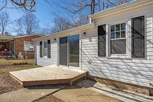 exterior space with fence and a wooden deck