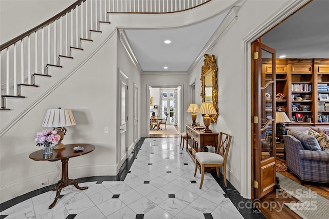 foyer entrance featuring stairway, baseboards, ornamental molding, and recessed lighting