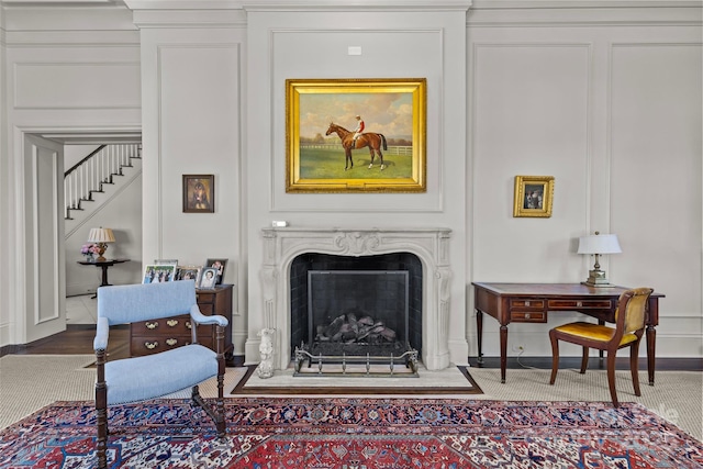 sitting room with a fireplace and a decorative wall