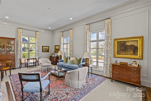 living area featuring recessed lighting and crown molding