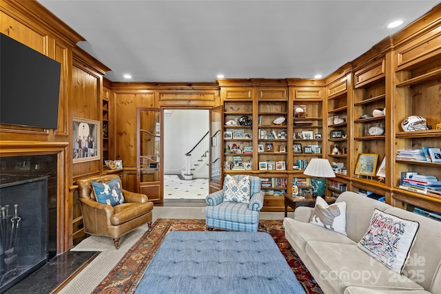 living area featuring built in features, recessed lighting, and a premium fireplace