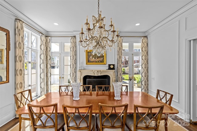 dining room featuring a healthy amount of sunlight, wood finished floors, crown molding, and french doors