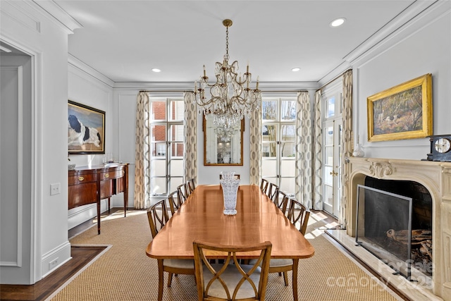 dining room featuring ornamental molding, plenty of natural light, and a premium fireplace