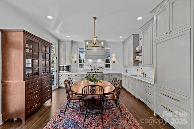 dining area featuring a notable chandelier, dark wood finished floors, and recessed lighting