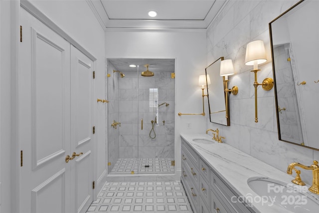 full bathroom with ornamental molding, a sink, a shower stall, and double vanity