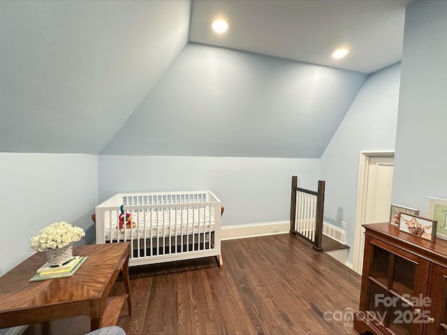 bedroom featuring lofted ceiling, a nursery area, recessed lighting, and wood finished floors