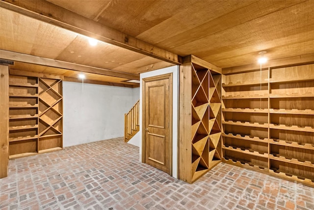 wine cellar with brick floor and wood ceiling