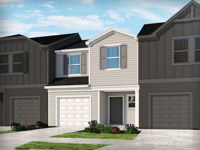 view of property with a garage, concrete driveway, and board and batten siding