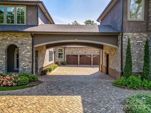 1905 White Tree Trl, Arden, NC 28704 - view of property exterior with stucco siding, decorative driveway, and stone siding
