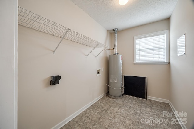 laundry room featuring baseboards, washer hookup, water heater, laundry area, and a textured ceiling