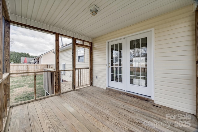 unfurnished sunroom featuring a wealth of natural light and wood ceiling