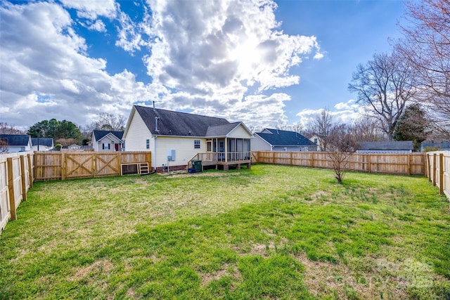 view of yard with a fenced backyard and a wooden deck