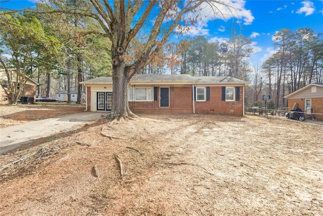 single story home with crawl space, driveway, and brick siding