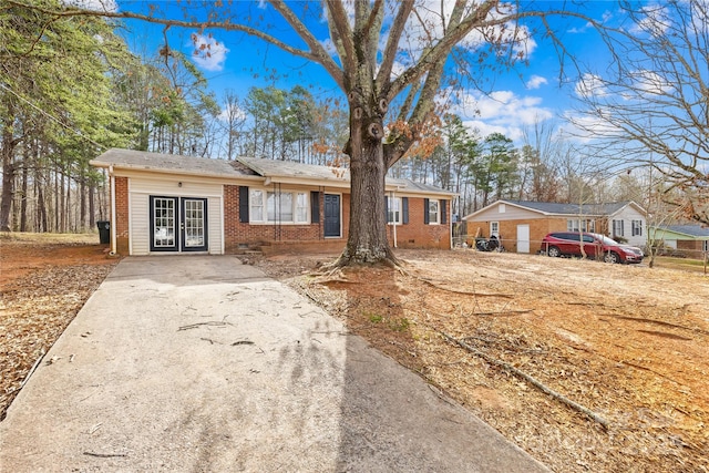 ranch-style house with french doors, brick siding, and crawl space