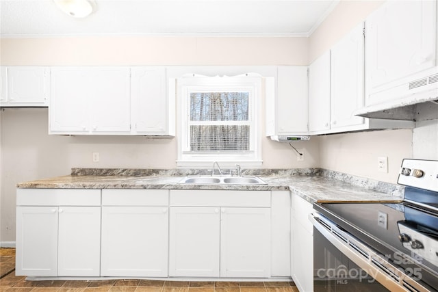 kitchen with light countertops, ornamental molding, electric stove, white cabinets, and a sink