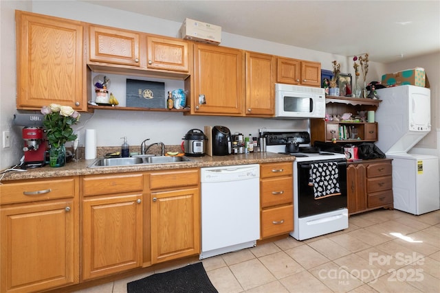 kitchen with light tile patterned floors, open shelves, stacked washer / drying machine, a sink, and white appliances