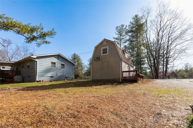 view of side of home featuring crawl space and a gambrel roof