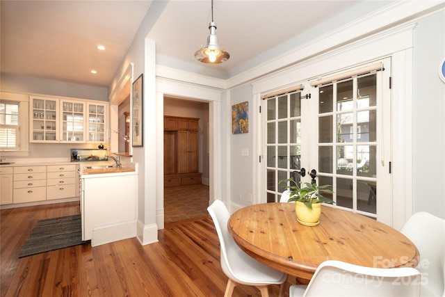 dining room with recessed lighting, baseboards, and wood finished floors