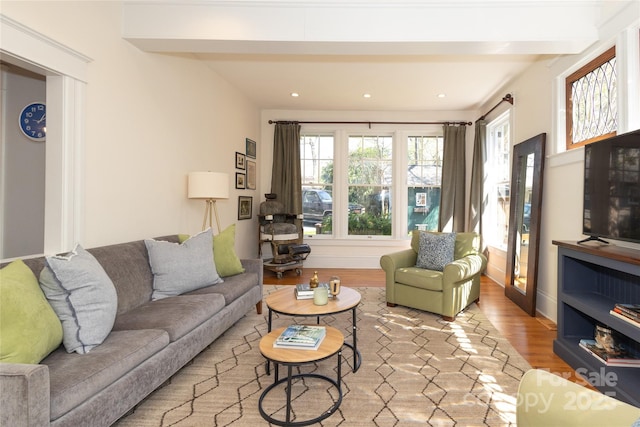 living room featuring baseboards, wood finished floors, recessed lighting, and beam ceiling