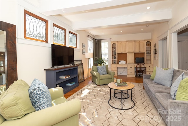 living room with light wood-style flooring, beam ceiling, and recessed lighting