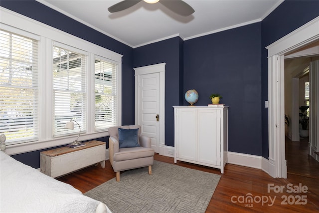 bedroom with baseboards, wood finished floors, ornamental molding, and a ceiling fan