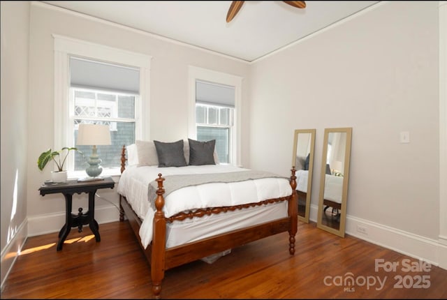 bedroom with baseboards, wood finished floors, and a ceiling fan