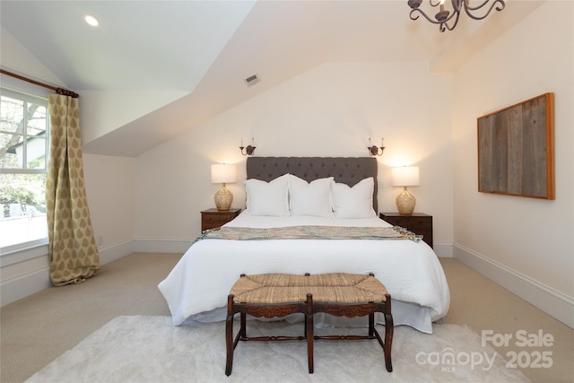 bedroom featuring baseboards, lofted ceiling, visible vents, and an inviting chandelier