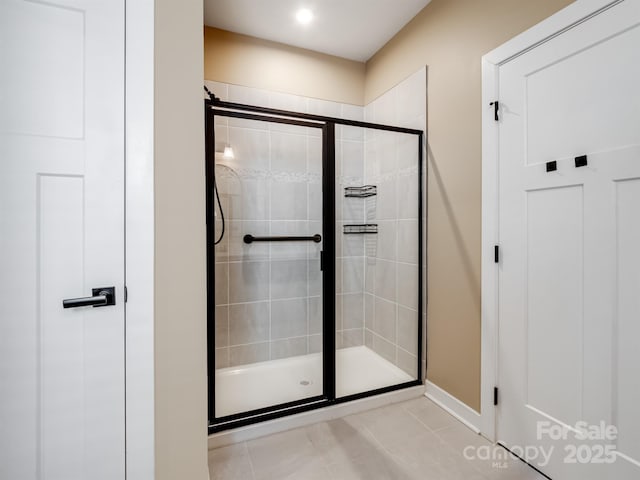 full bath featuring a stall shower and tile patterned floors