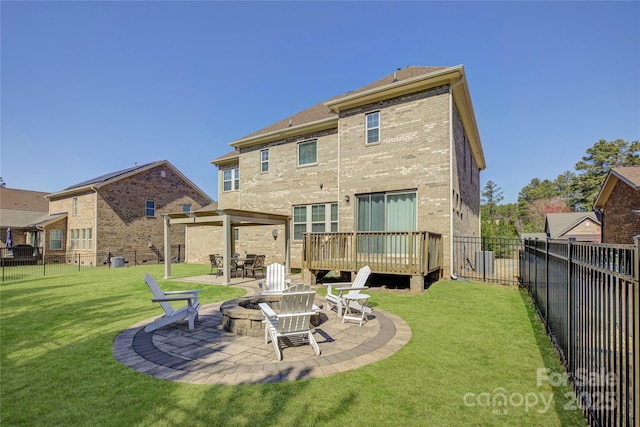 rear view of house featuring a patio, a yard, a fenced backyard, and brick siding