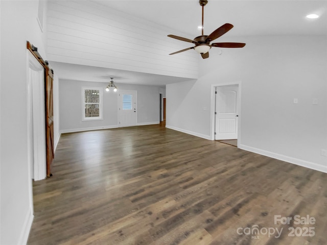 unfurnished living room featuring high vaulted ceiling, a barn door, a ceiling fan, baseboards, and dark wood-style floors