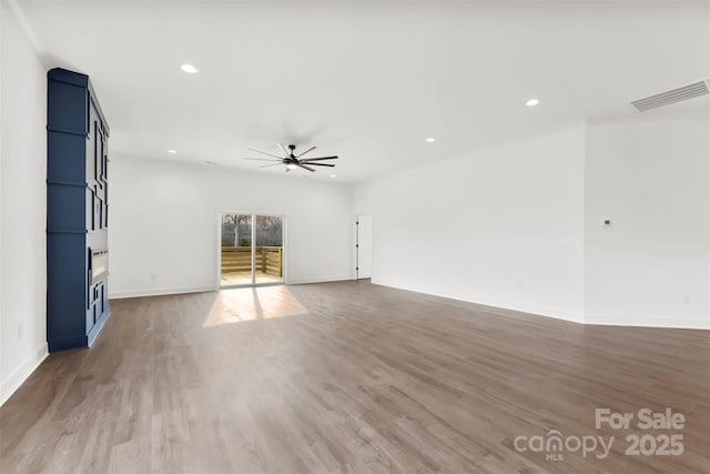 unfurnished room featuring baseboards, visible vents, ceiling fan, wood finished floors, and recessed lighting